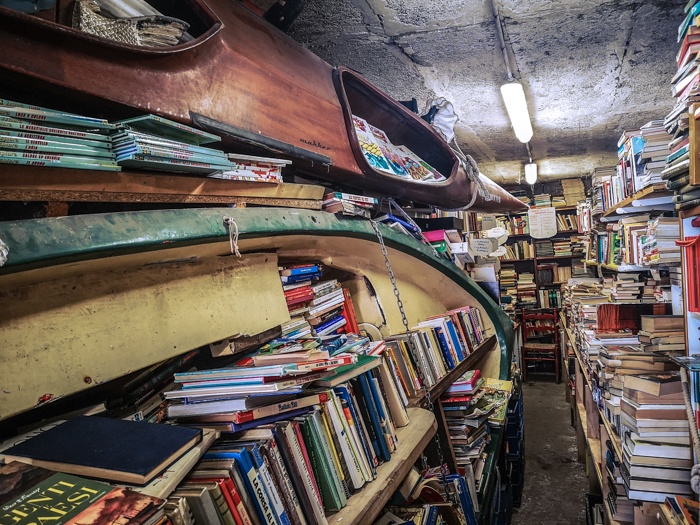 the boats of Libreria Acqua Alta Bookshop in Venice Italy has boats, kayaks and even bathtubs full of books to prevent damage during the yearly rising of the waters (acqua alta)