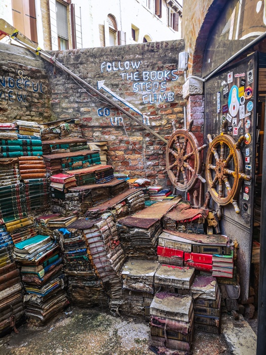 the book-steps of Libreria Acqua Alta in Venice are a highlight of anyone's visit. Climb up and from here you can see right over the wall to the canals below.