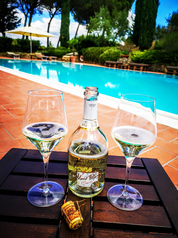 Relaxing by the pool of La Mormoraia with one of their speciality bottles of fizz