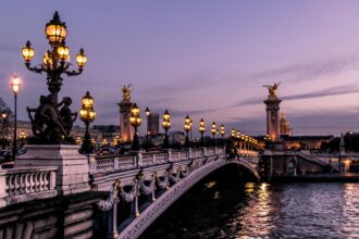 A bridge over the River Seine in Paris at night.