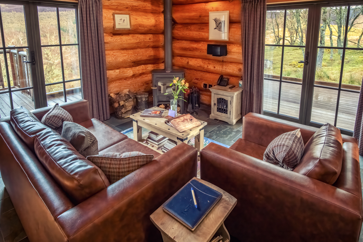 Cosy wooden interior of Eagle Brae luxury log cabin with log burner and handcrafted furnishings in the Scottish Highlands