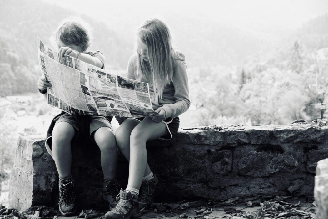A boy and a girl reading a map