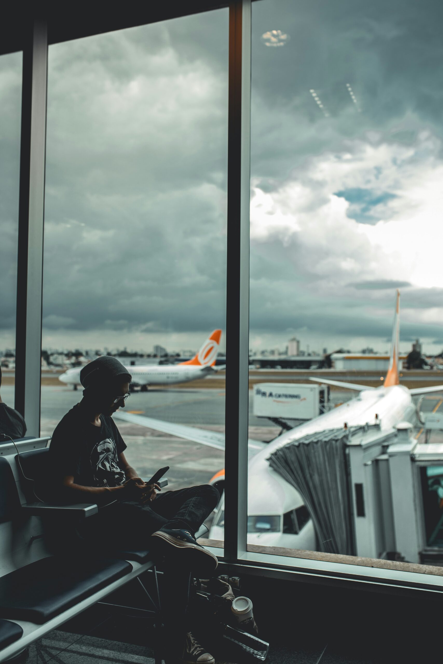 On the phone and laptop at the airport